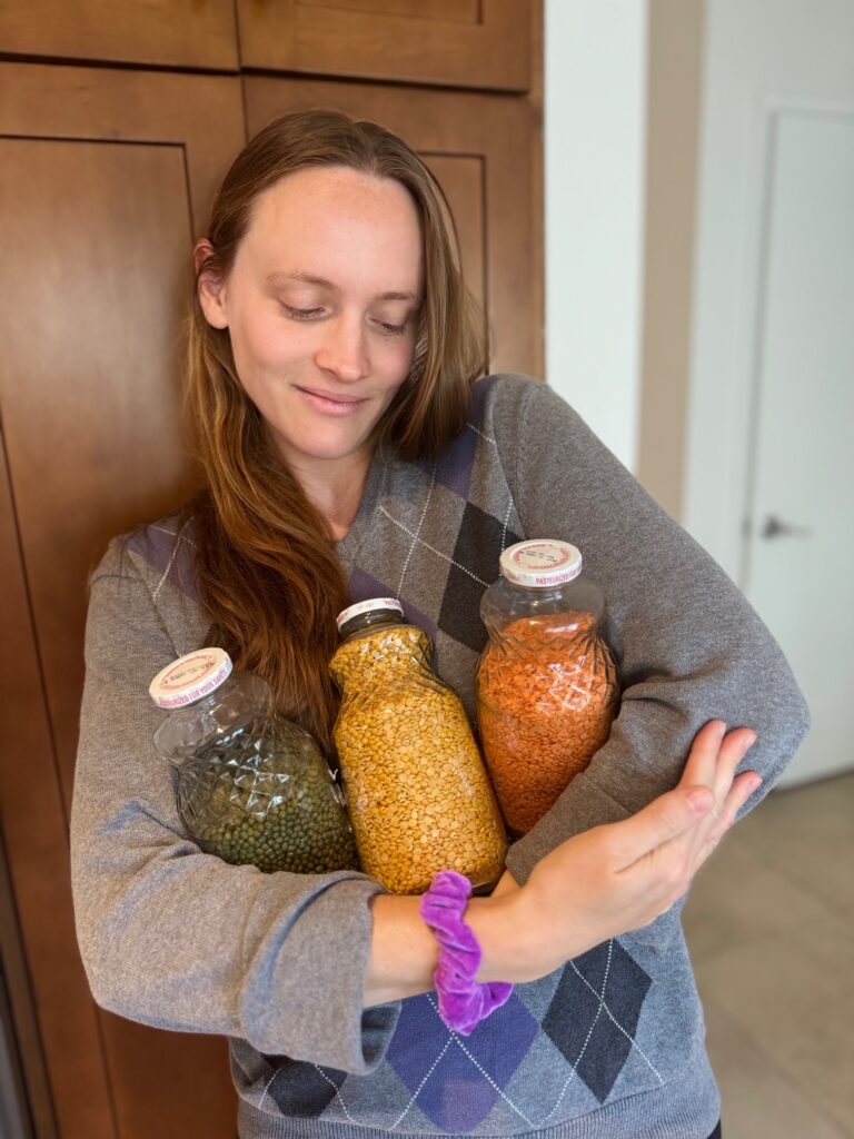Jennifer Wall, Kitchen Coach, holding jars of lentils and beans