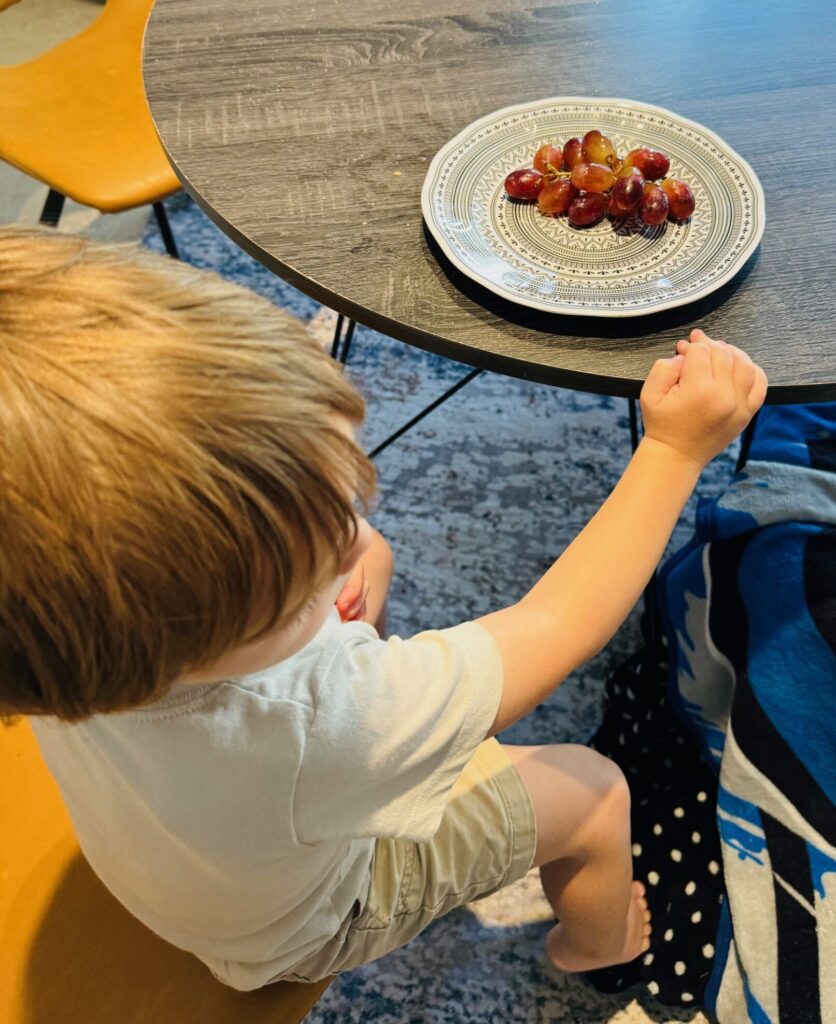 Child eating grapes