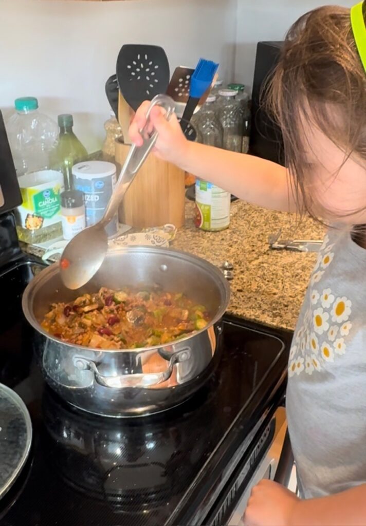 A child helping to cook dinner